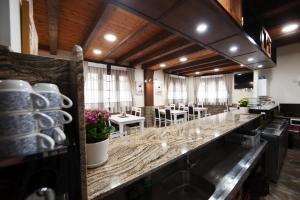 a bar in a restaurant with tables and chairs at VILLA DOS INFANTAS in Puebla de Sanabria