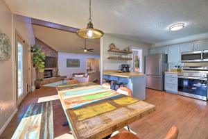 a kitchen and dining room with a wooden table at Modern Fayetteville Home Less Than 1 Mi to U of A! in Fayetteville