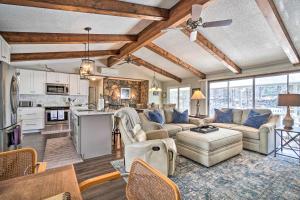 a living room with a couch and a table at Cozy Lake Santeetlah Cottage with Dock and 3 Kayaks! in Robbinsville