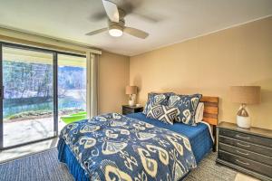 a bedroom with a bed and a large window at Cozy Lake Santeetlah Cottage with Dock and 3 Kayaks! in Robbinsville