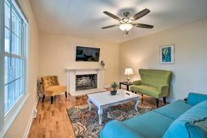 a living room with a blue couch and a fireplace at Apache Trail Home - 3 Mi to Masonboro Island! in Wrightsville Beach