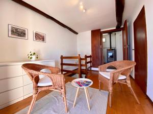 a living room with chairs and a table at Casa Edi in Locarno