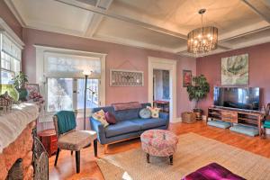 a living room with a couch and a tv at The Purple House Apt in Downtown Flagstaff! in Flagstaff