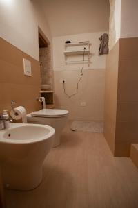 a bathroom with a toilet and a sink in it at la casetta in Sassari