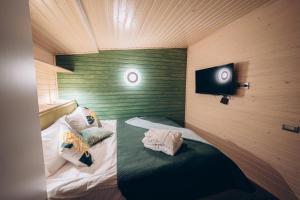 a small room with a bed and a tv at Space Place in Yablunytsya