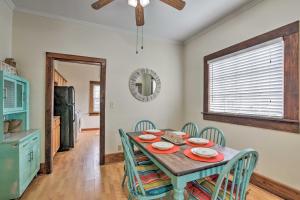 a dining room with a wooden table and chairs at Galveston ‘Blue Bungalow’ - Walk to Beach! in Galveston
