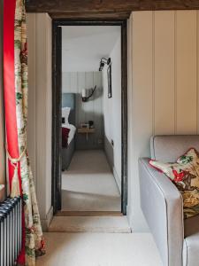 a hallway leading into a bedroom with a mirror at Hare And Hounds Newbury in Newbury