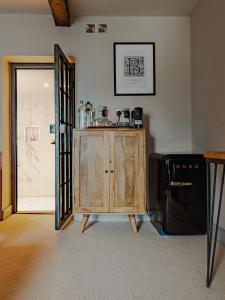 a room with a wooden cabinet next to a door at Hare And Hounds Newbury in Newbury