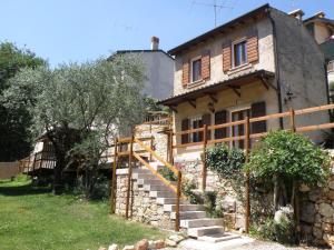 an old stone house with stairs leading up to it at Ca' Spina: Sweet Home in Valpolicella in SantʼAmbrogio di Valpolicella