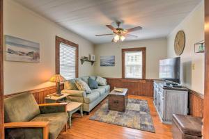 a living room with a couch and a tv at Galveston ‘Blue Bungalow’ - Walk to Beach! in Galveston