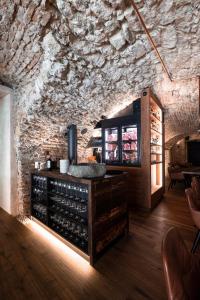 a wine tasting room with a stone wall at Hotel Alte Post Südsteiermark in Leibnitz