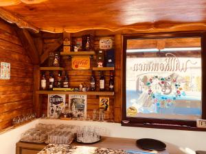 a bar with a window in a wooden cabin at Casa Dudu in Moieciu de Jos