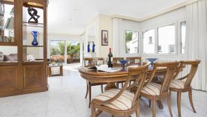 a dining room with a wooden table and chairs at 1Albo01 - Llafranc in Calella de Palafrugell