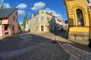 a group of buildings on a city street at Penzion Novopacké Sklepy in Nová Paka