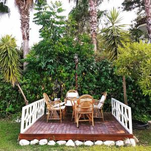 una terraza de madera con mesa y sillas. en LAGİNA BOUTİQUE HOTEL, en Kemer