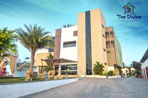 a building with some statues in front of it at The Divine Resort Somnath in Somnath