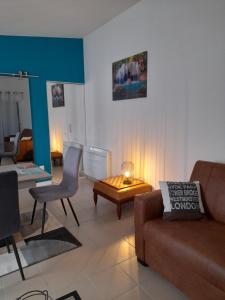 a living room with a couch and a table at La Pépite de l'océan in Saint-Nazaire