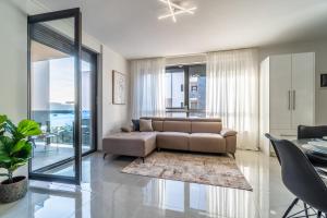 a living room with a brown couch and a table at Apartment Laurel in Medulin