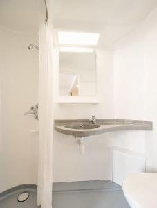 a bathroom with a sink and a toilet at Generator Hamburg in Hamburg +53 photos