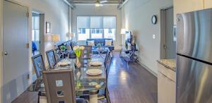 a living room with a long table and a kitchen at Midtown Fully Furnished Apartments - Great Location apts in Atlanta