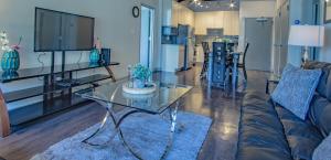a living room with a couch and a glass table at Midtown Fully Furnished Apartments - Great Location apts in Atlanta