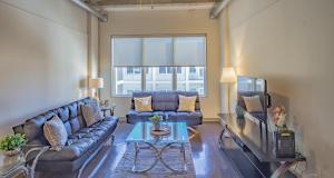 a living room with a couch and a tv at Midtown 1BR Fully Furnished Apartment - Great Location! apts in Atlanta