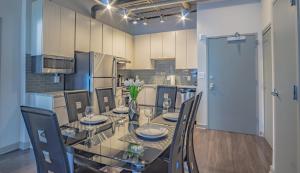 a dining room with a glass table and chairs at Midtown 1BR Fully Furnished Apartment - Great Location! apts in Atlanta