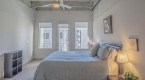 a bedroom with a large bed with two windows at 2BR Fully Furnished Apartment - Great location in Midtown apts in Atlanta