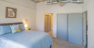 a bedroom with a blue bed and a door at 2BR Fully Furnished Apartment - Great location in Midtown apts in Atlanta