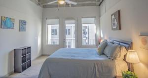 a bedroom with a bed and two windows at 2BR Fully Furnished Apartment - Great location in Midtown apts in Atlanta