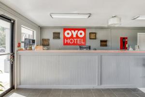 a restaurant counter with a hotel sign above it at OYO Hotel Pineville LA Hwy 165 in Pineville