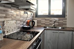 a kitchen with a sink and a stove top oven at Khibra 3 in Volos