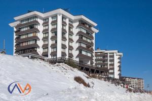 a large building on top of a snow covered hill at Apartamento El Colorado in El Colorado