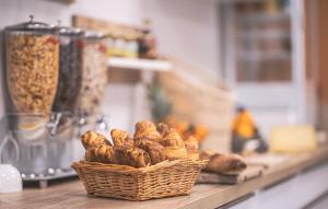 a basket of bread on a counter in a kitchen at Hotel - Restaurant Les 3 Piliers in Le Boupère