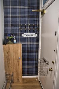 a hallway with a shower with a sign on the wall at Modern & Cosy apartment in the heart of the historic old town of Aberdeen, free WiFi, free parking in Aberdeen