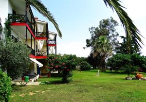 a view of a building with a yard at Karpetis a green paradise in Psakoudia