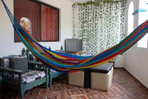 a hammock in a living room with a tv at Hotel Maggic Home Panorámica in Guanajuato