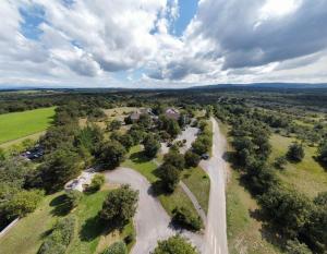 an aerial view of a road in a field with trees at Hôtel Causse Comtal Rodez, The Originals Relais in Gages-le-Haut