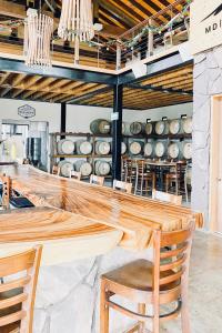 a dining room with a wooden table and chairs at Finca el Mirador in Valle de Guadalupe +40 photos
