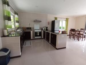 a kitchen with a refrigerator and a counter top at Jaidss Holiday Apartments 2 in Victoria +16 photos