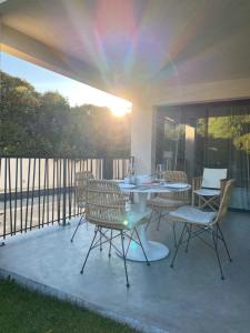 a patio with a table and chairs with the sun shining at STUDIO in res. LES CYCLISTES in Malaucène
