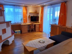 a living room with a couch and a table at Hoislbauerngut in Bad Hofgastein