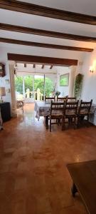 a large living room with a table and chairs at maison nathalia in Jávea