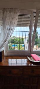 a room with a window and a table with a plate at maison nathalia in Jávea