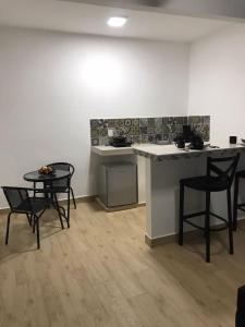 a kitchen with a table and chairs in a room at Garden Suites Comalcalco in Comalcalco