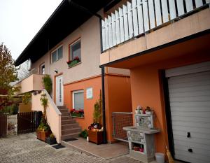 a house with a garage and a stairway at Apartma Metka Leše Tržič in Leše