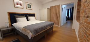 sypialnia z dużym łóżkiem i ceglaną ścianą w obiekcie Apartamenty SIENKIEWICZA 8 w Żywcu