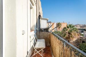 a bench sitting on the balcony of a building at Casa Cosi - La Gleva 4 in Barcelona