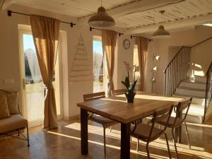 a dining room with a wooden table and chairs at le bastidon in Villars