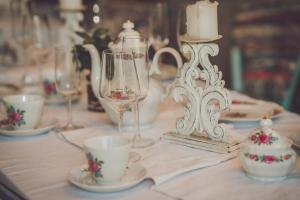 a table with cups and glasses on a table at Ribarska kuća - Ilok ,tradicijska kuća-sobe in Ilok